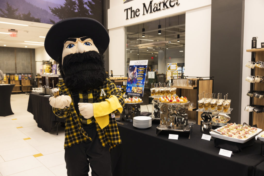 Yosef mascot next to food