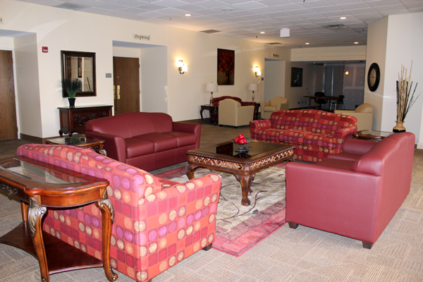 Sitting area with red couches around a table