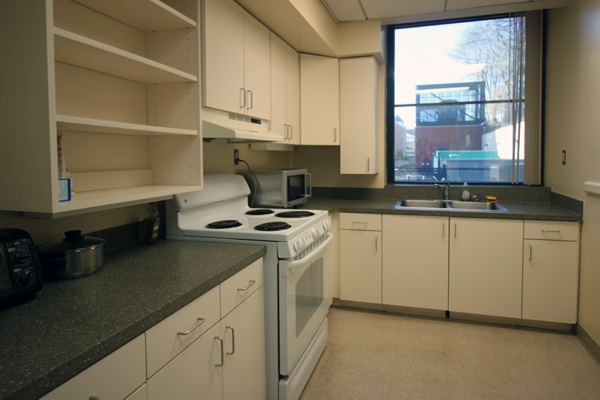 Kitchen with stove, microwave, and sink